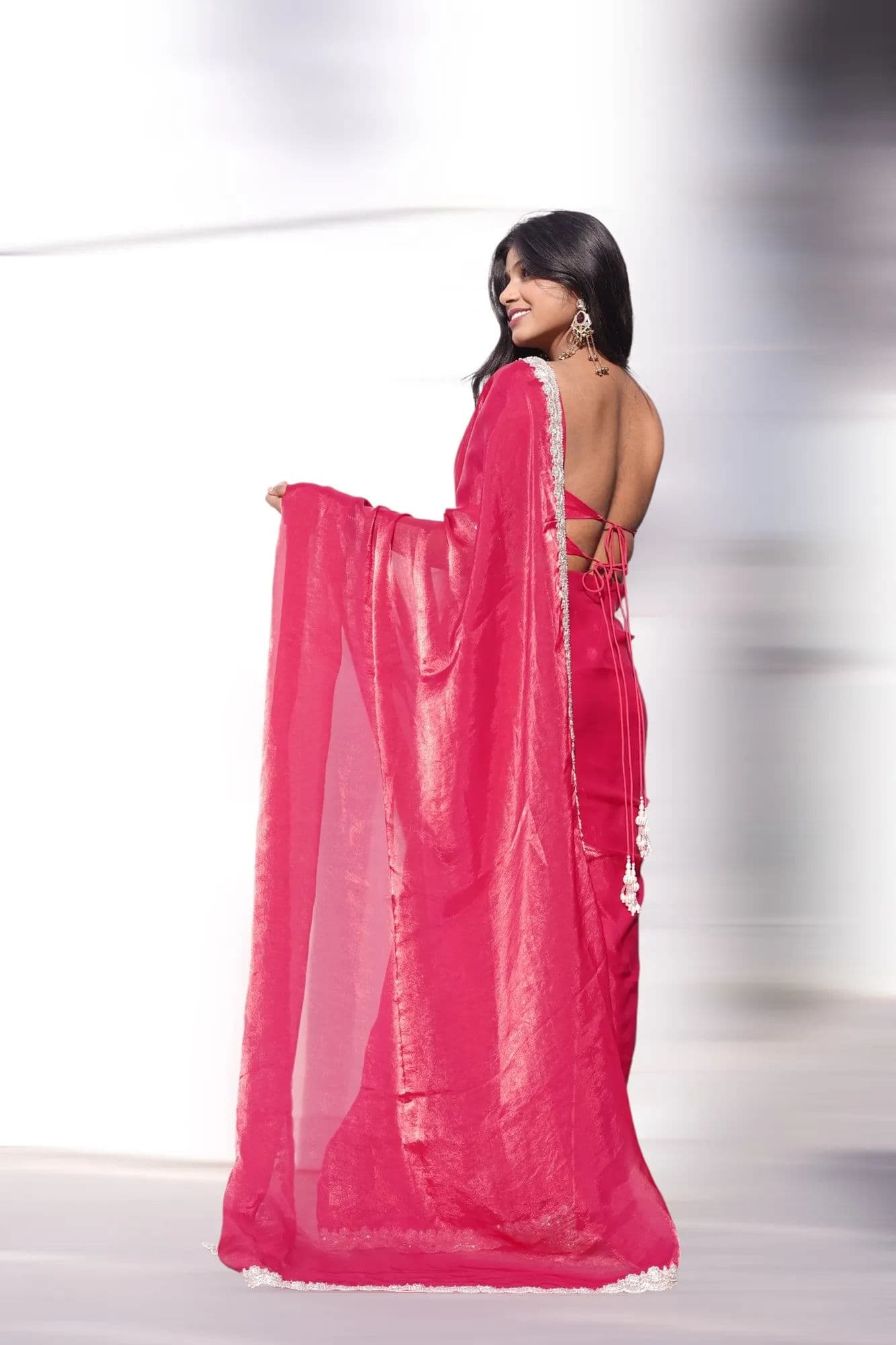 Bright pink saree with white lace border