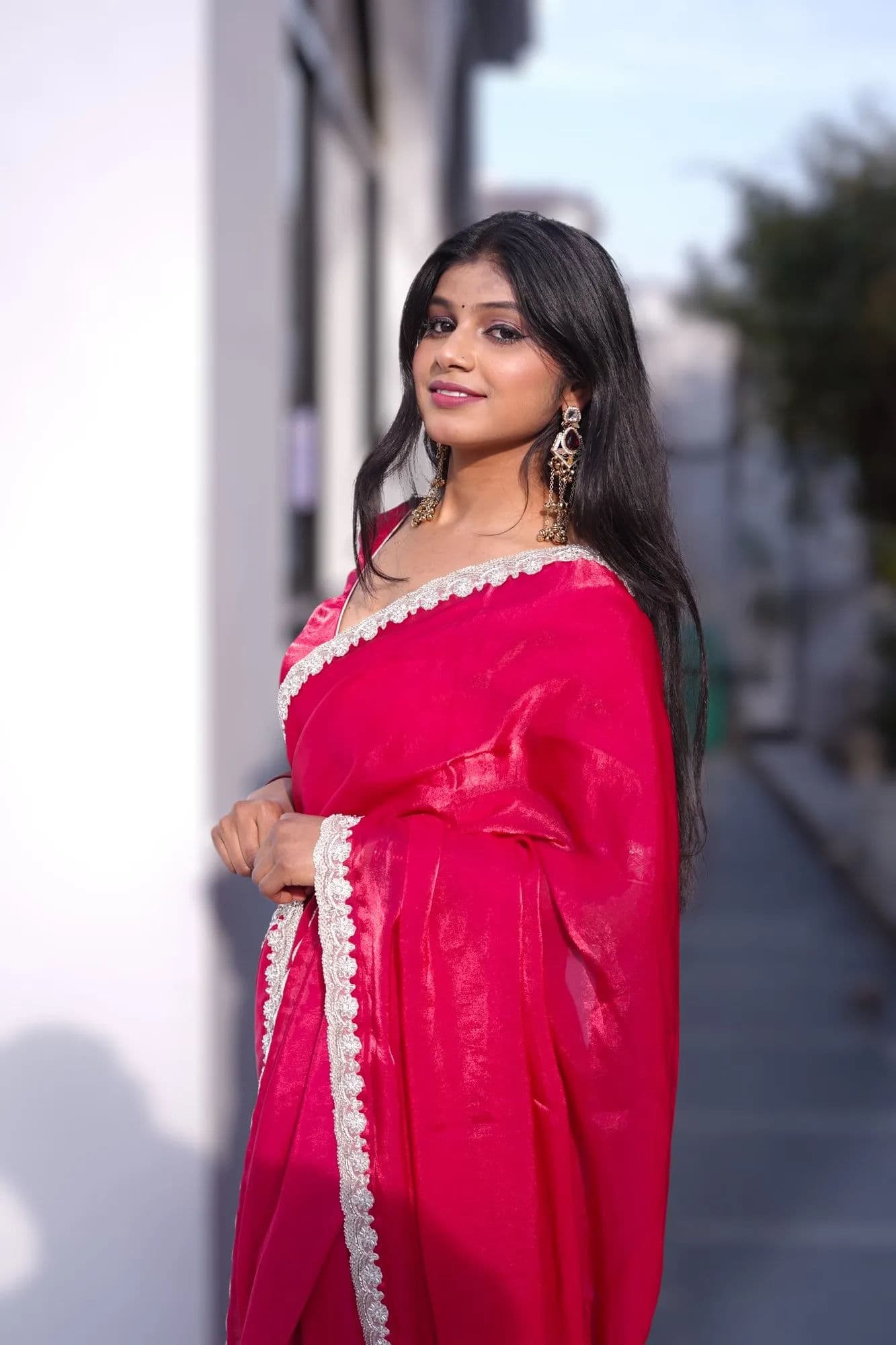 Bright pink saree with white lace border