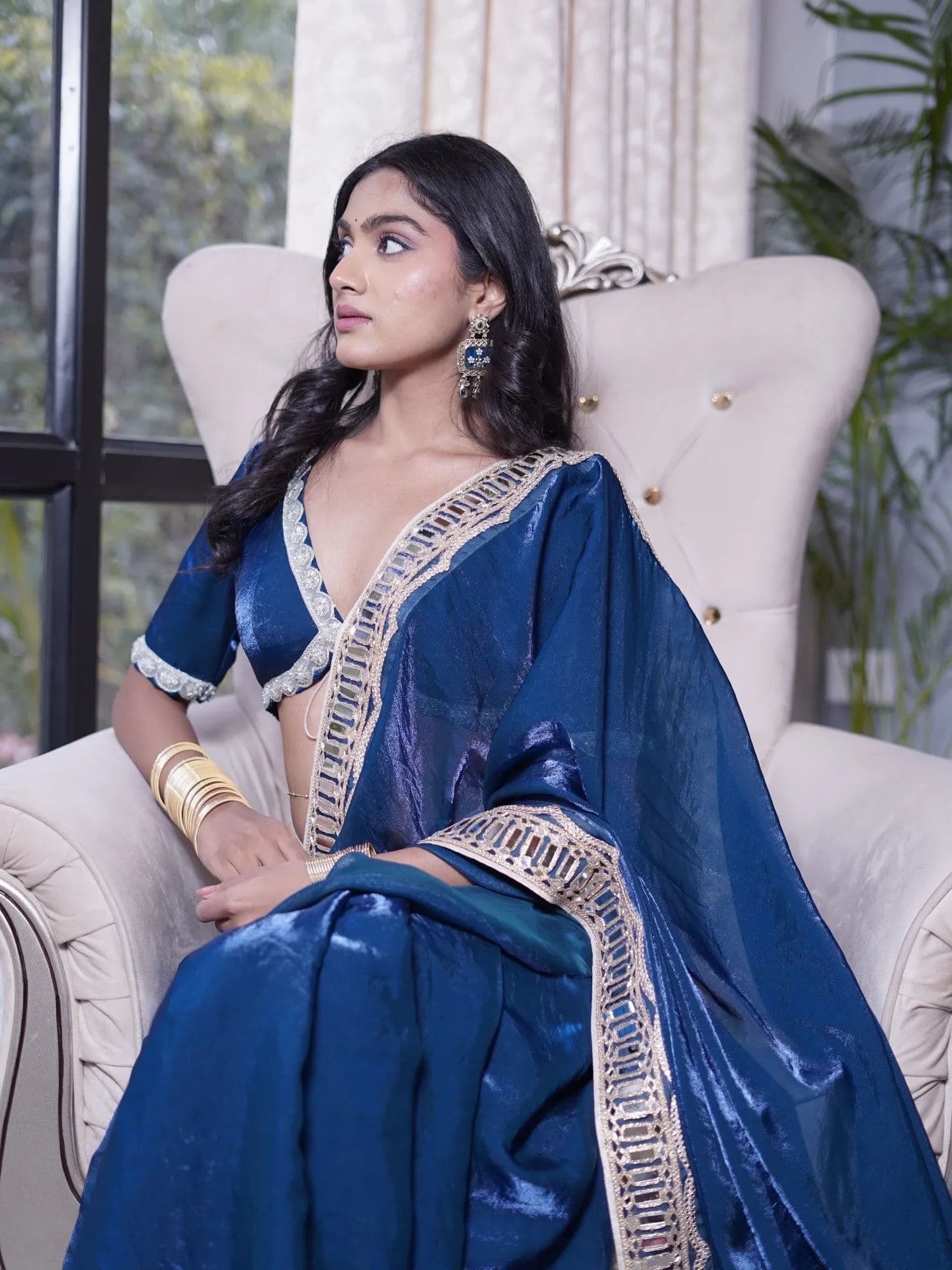 Teal silk saree with white and gold embroidered border